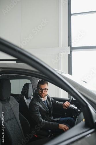 Young man in the car dealership. © Serhii