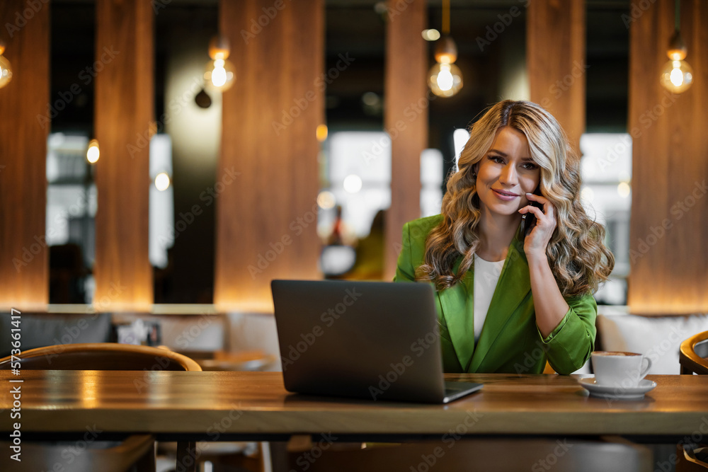 Beautiful middle aged woman using laptop at cafe Beautiful middle aged woman using laptop at cafe