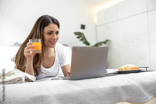 Smiling businesswoman working on laptop from home office