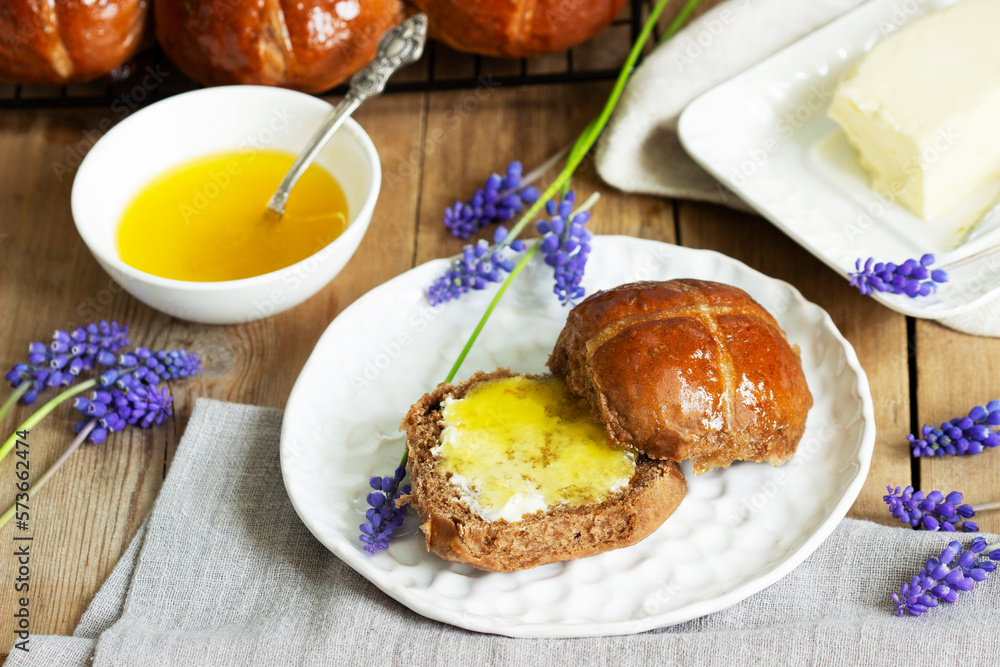 Chocolate cross buns served with butter and honey. Traditional Easter baking.