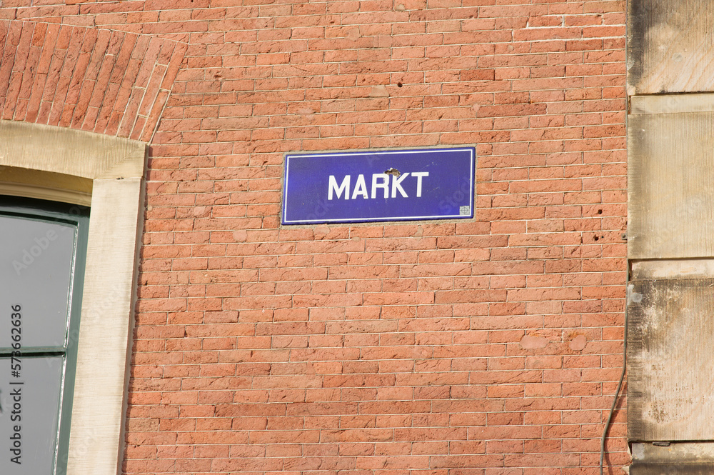 Blue street name sign of Markt on a brick stone wall  in Arnhem in the Netherlands