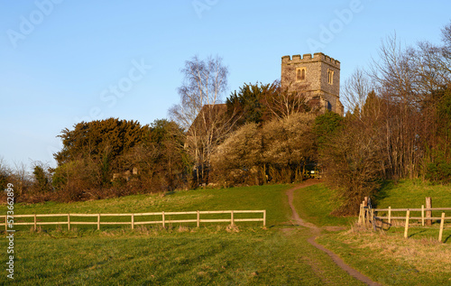 Canvas Print Church in the English countryside with field and trees