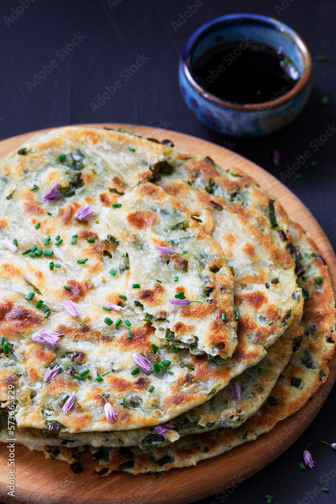 Homemade appetizing scallion pancakes served with soy sauce.