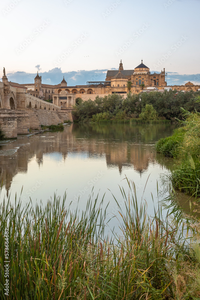 Exposure at sunset of the Roman bridge of and the Mosque–Cathedral of Cordoba in the background with the Guadalquivir river in the foreground Exposure at sunset of the Roman bridge of and the Mosque–Cathedral of Cordoba in the background with the Guadalquivir river in the foreground
