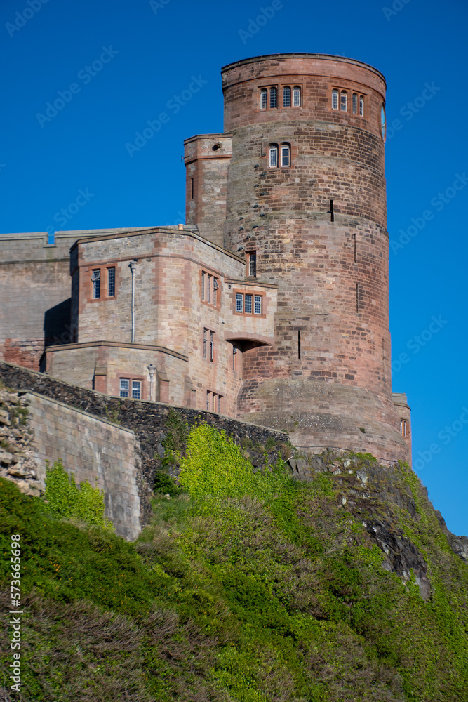 Bamburgh Castle tower against a bright blue summer sky. Northumberland, UK	