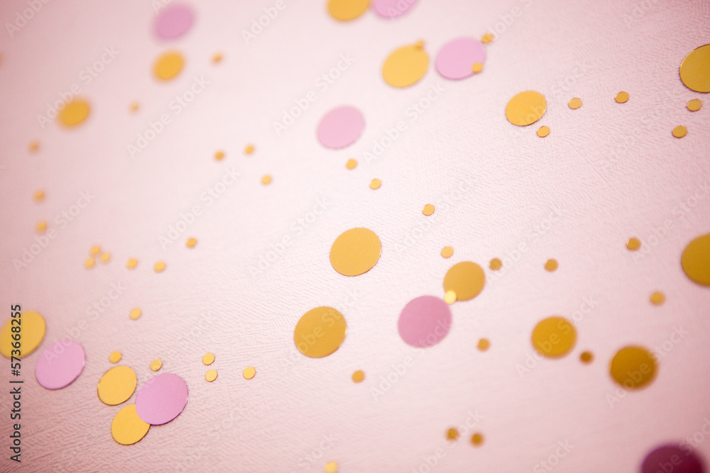 Light pink celebration background with glittering gold confetti decoration and bokeh Light pink celebration background with glittering gold confetti decoration and bokeh