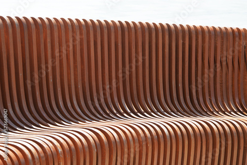 Brown wooden vertical slats. Building facade element. Beautiful abstract background.