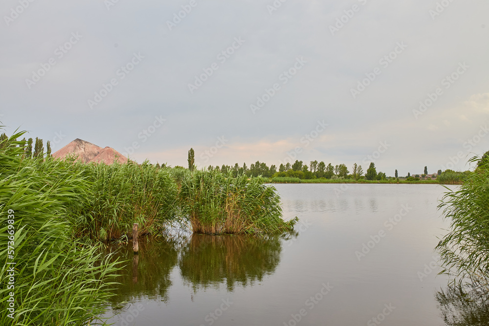 Lake near the slag dump. Industrial Donbass landscape.