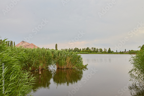 Lake near the slag dump. Industrial Donbass landscape.