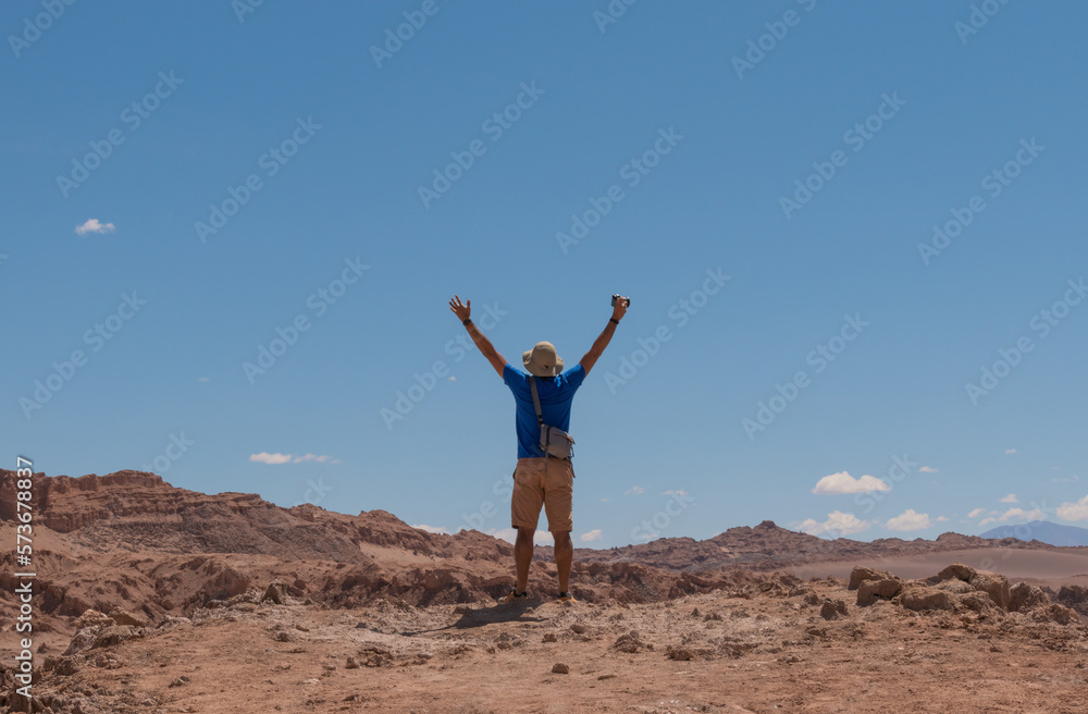 Happy young Photographer in the Atacama Desert - The valley of death. with arms wide open Happy young Photographer in the Atacama Desert - The valley of death. with arms wide open