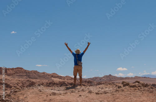 Happy young Photographer in the Atacama Desert - The valley of death. with arms wide open