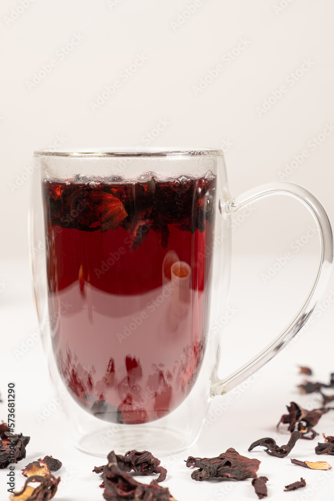 Red hibiscus tea from the petals of the Sudanese rose in a glass cup with a double bottom Red hibiscus tea from the petals of the Sudanese rose in a glass cup with a double bottom