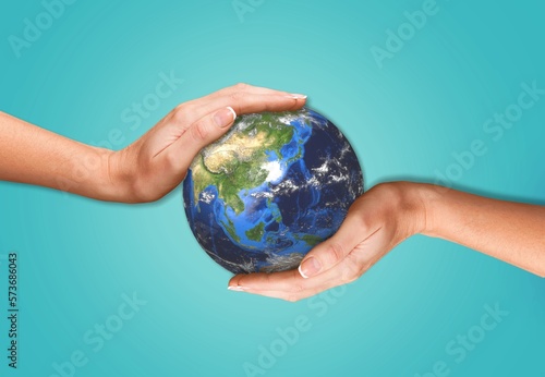 Concept of Earth Day. Hands hold a Globe.