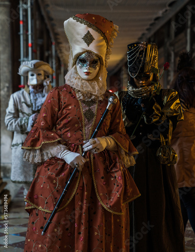 People wearing elaborate masks and costumes during the Venice carnival 