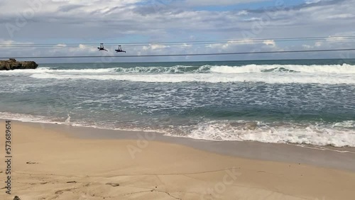 Adrenaline Beach at Labadee, Haiti. Dragon's Fire and Dragon's Breath zipline. Labadee is a private resort leased by Royal Caribbean Cruises. Superman style zip line over Caribbean beach and waves. photo