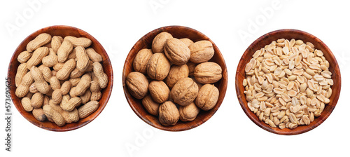 Peanuts background. Vegetarian diet food. Nuts in shells inside round wooden bowl isolated. Snacks in a bowl. Healthy party snack. Hulled peanuts without shell. Walnuts diet.