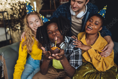 Group of diverse friends, young cheerful men and women, college university international students celebrating birthday anniversary looking happy, smiling. Multi cultural miltiracial people have fun