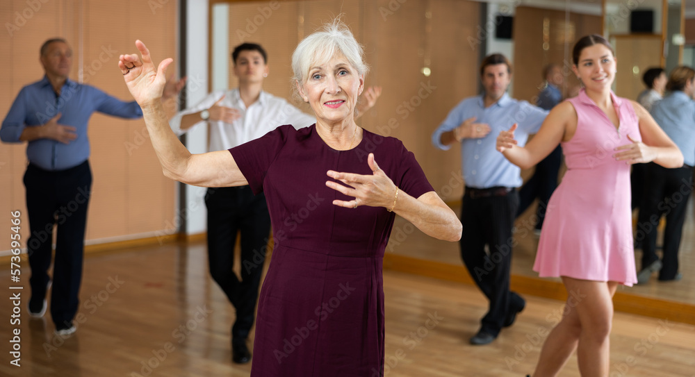 mature woman became in starting position before start of paso doble dance