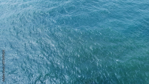 Blue water texture. Top view of the ocean surface with waves © Payllik