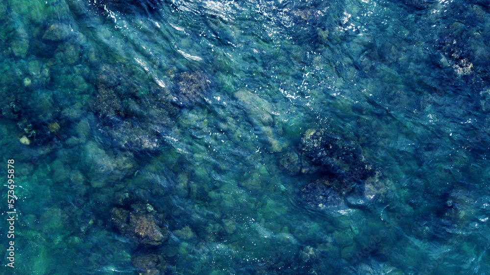 Blue water texture. Top view of the ocean surface with waves