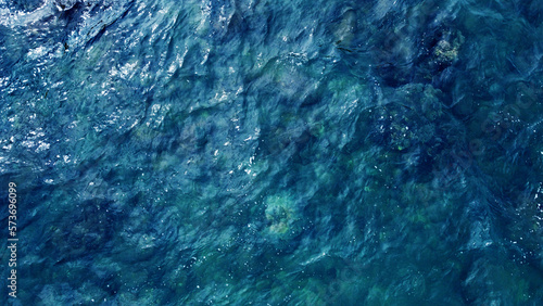 Blue water texture. Top view of the ocean surface with waves