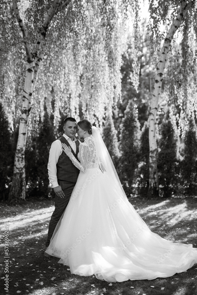young couple the groom in a plaid suit and the bride in a chic white dress young couple the groom in a plaid suit and the bride in a chic white dress