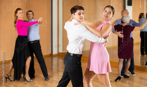 young woman in dance studio studying with her partner to dance pairs ballroom dance waltz