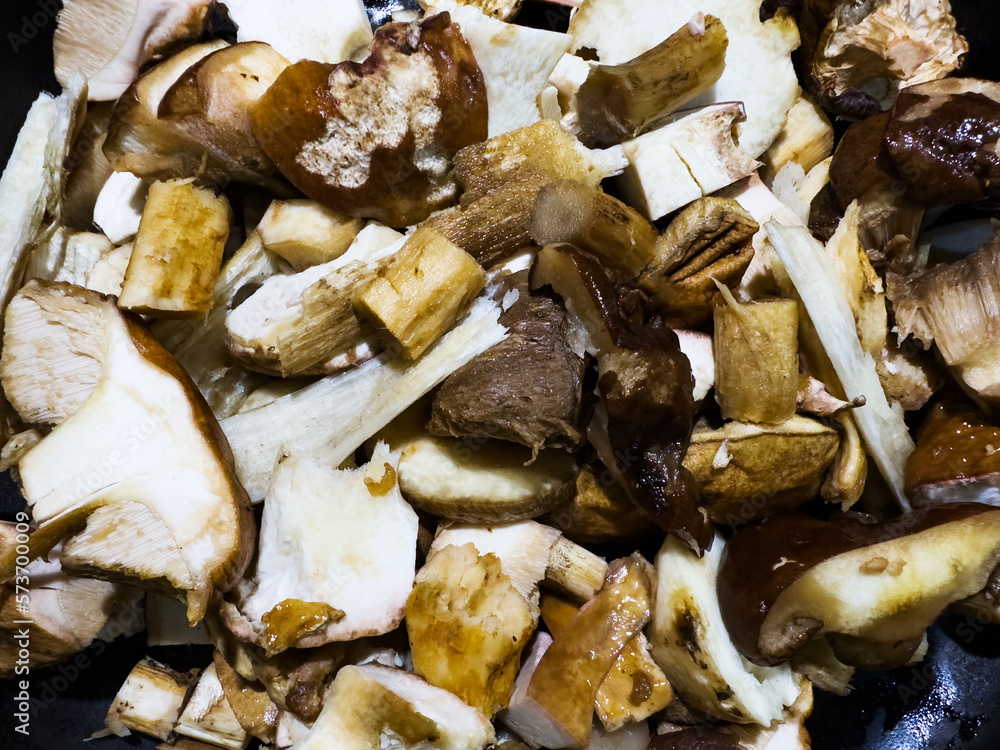 Many Penny Bun Fungus mushrooms cut on cooking table Many Penny Bun Fungus mushrooms cut on cooking table