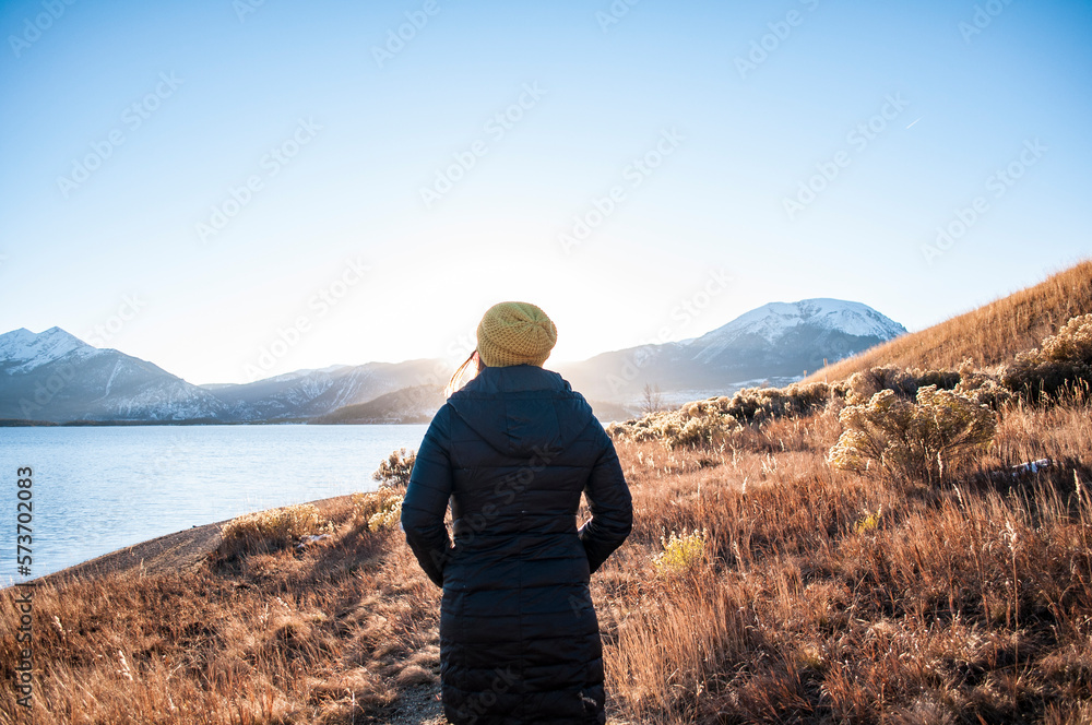 Young women walking down path at sunset in colorado. 