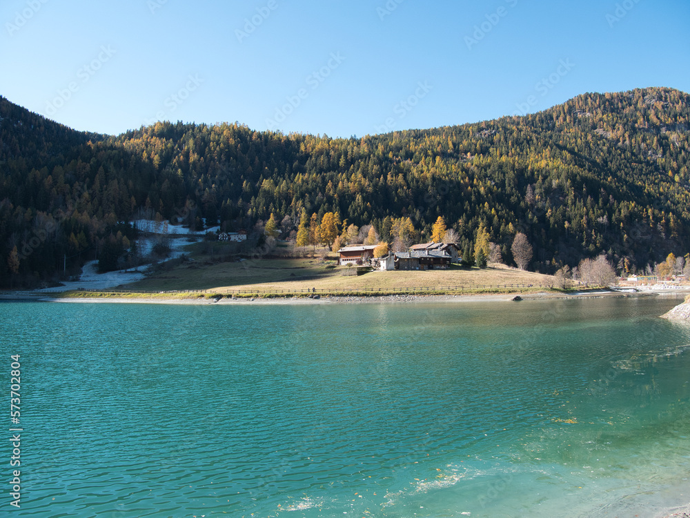 Brusson lake in autumn. Ayas valley, Italy.
