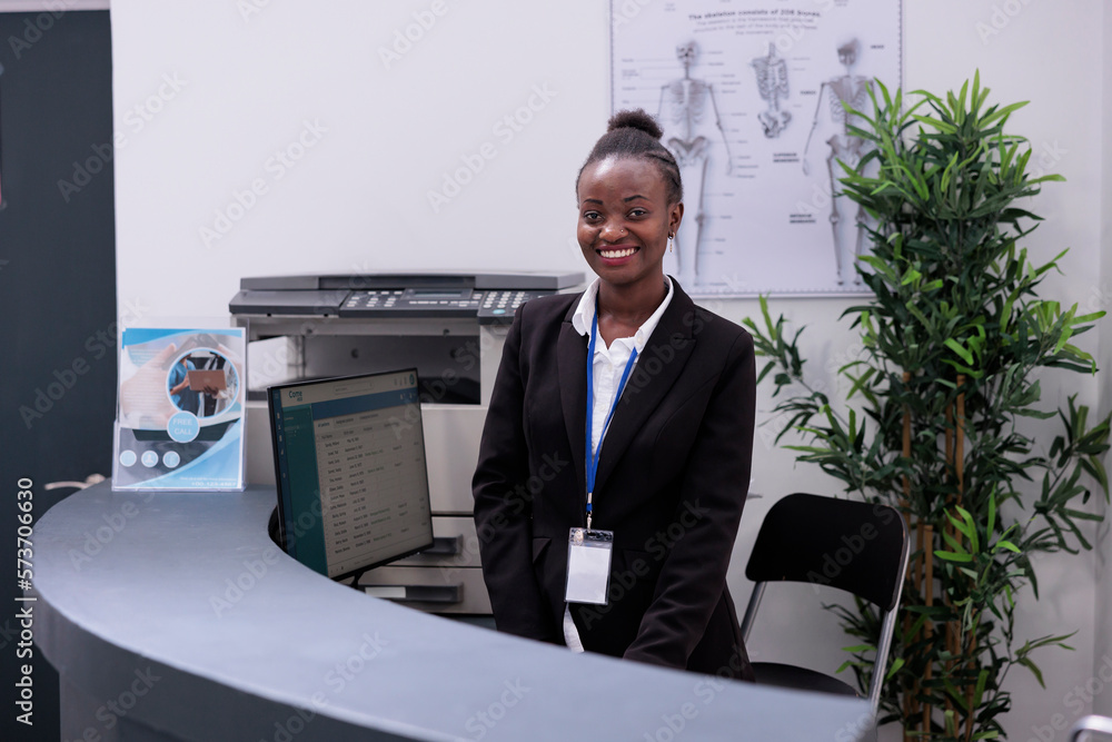 Foto de Portrait of african american receptionist standing at hospital ...
