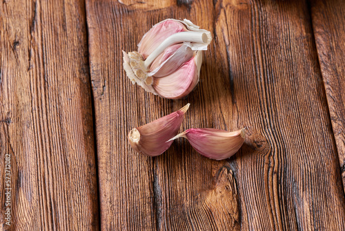 Garlic on the brown wooden table.