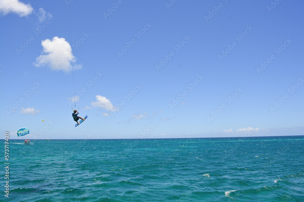 A kite surfer riding waves of Caribbean sea. A kite surfer riding waves of Caribbean sea.