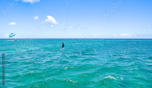 A kite surfer riding waves of Caribbean sea. 