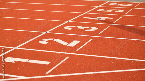Fototapeta Naklejka Na Ścianę i Meble -  The red runway is numbered at a stadium