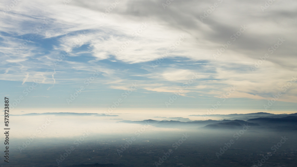 Sky with clouds over foggy plain