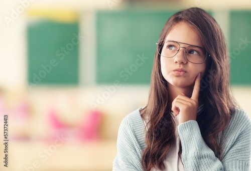 Cute small school child thinking about something