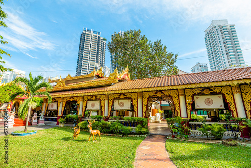 At Dhammikarama Burmese Buddhist temple in George Town, Penang, Malaysia, visitors can make pray at the Shrine of Buddha statue and throw coins at the offering bowls.
