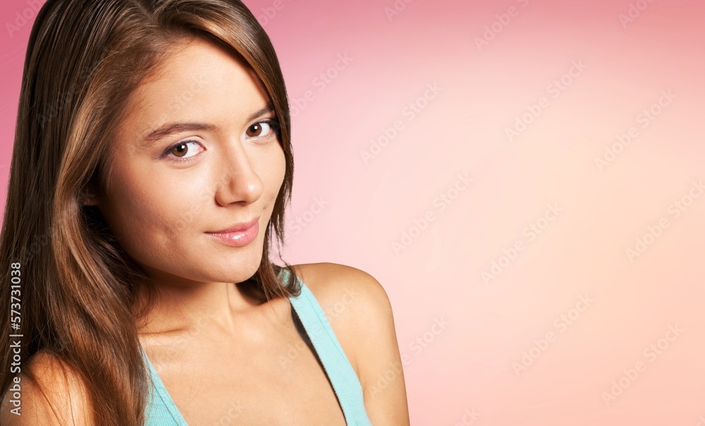 Smiling young woman posing on color background Smiling young woman posing on color background