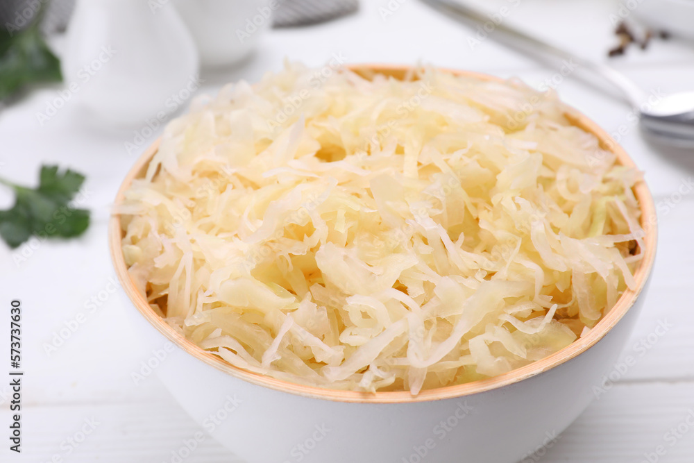 Bowl of tasty sauerkraut on white wooden table, closeup Bowl of tasty sauerkraut on white wooden table, closeup