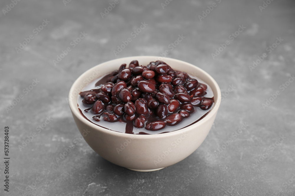 Bowl of canned kidney beans on grey table
