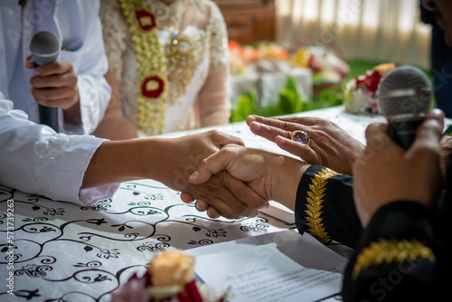 The marriage process for Indonesian Muslim brides is called "Ijab Kabul" in the "Marriage Agreement". handshake between son-in-law and father-in-law.