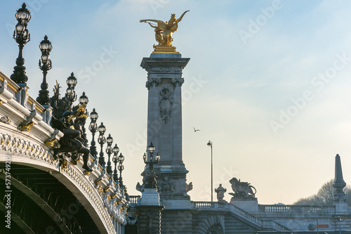 Alexandre III bridge against hazy blue sky in Paris, France
