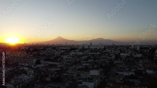 sunset in the city with volcanoes in the background, colors in the sky in the spring season in america, mexico, puebla 