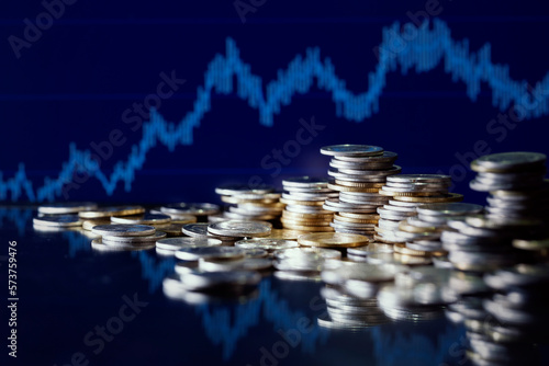 Double exposure image of coin stacks on technology financial graph background.Economy trends background for business ,financial meltdown ,Cryptocurrency digital economy.
