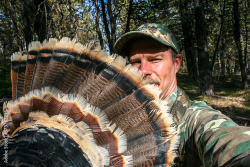 turkey hunter showing the fan tail of a Tom bird