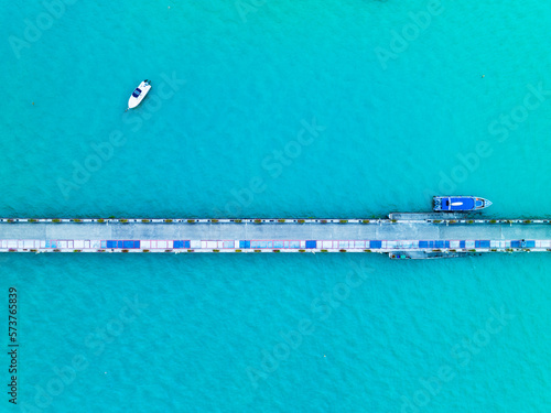 Aerial View Top down Drone shot of bridge with Yacht and sailboat parking in marina Transportation and travel background Beautiful sea in summer season