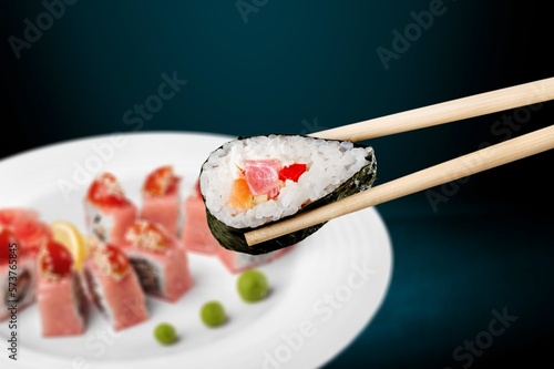 Wooden chopsticks and tasty fresh sushi dish
