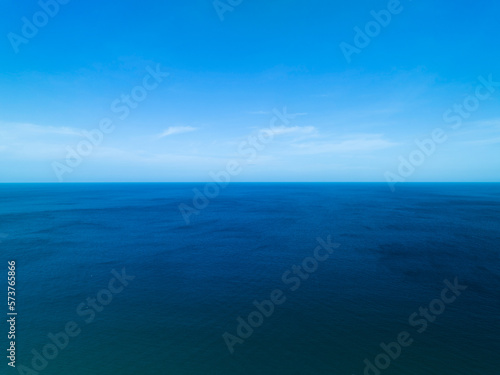 Aerial view of a blue sea surface water texture background and sun reflections Aerial flying drone view Waves water surface texture on sunny tropical ocean in Phuket island Thailand © panya99