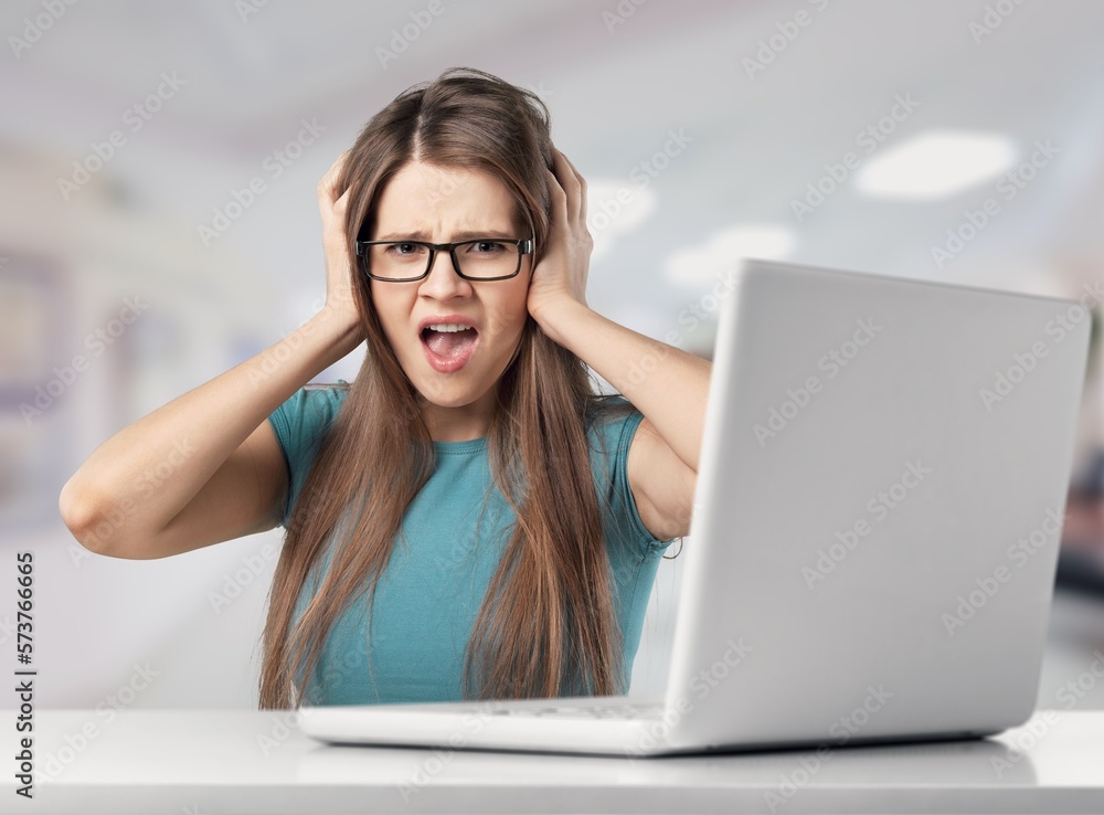 Young busy angry woman work on laptop Young busy angry woman work on laptop